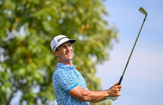 Thorbjorn Olesen hits a tee shot and watches the flight