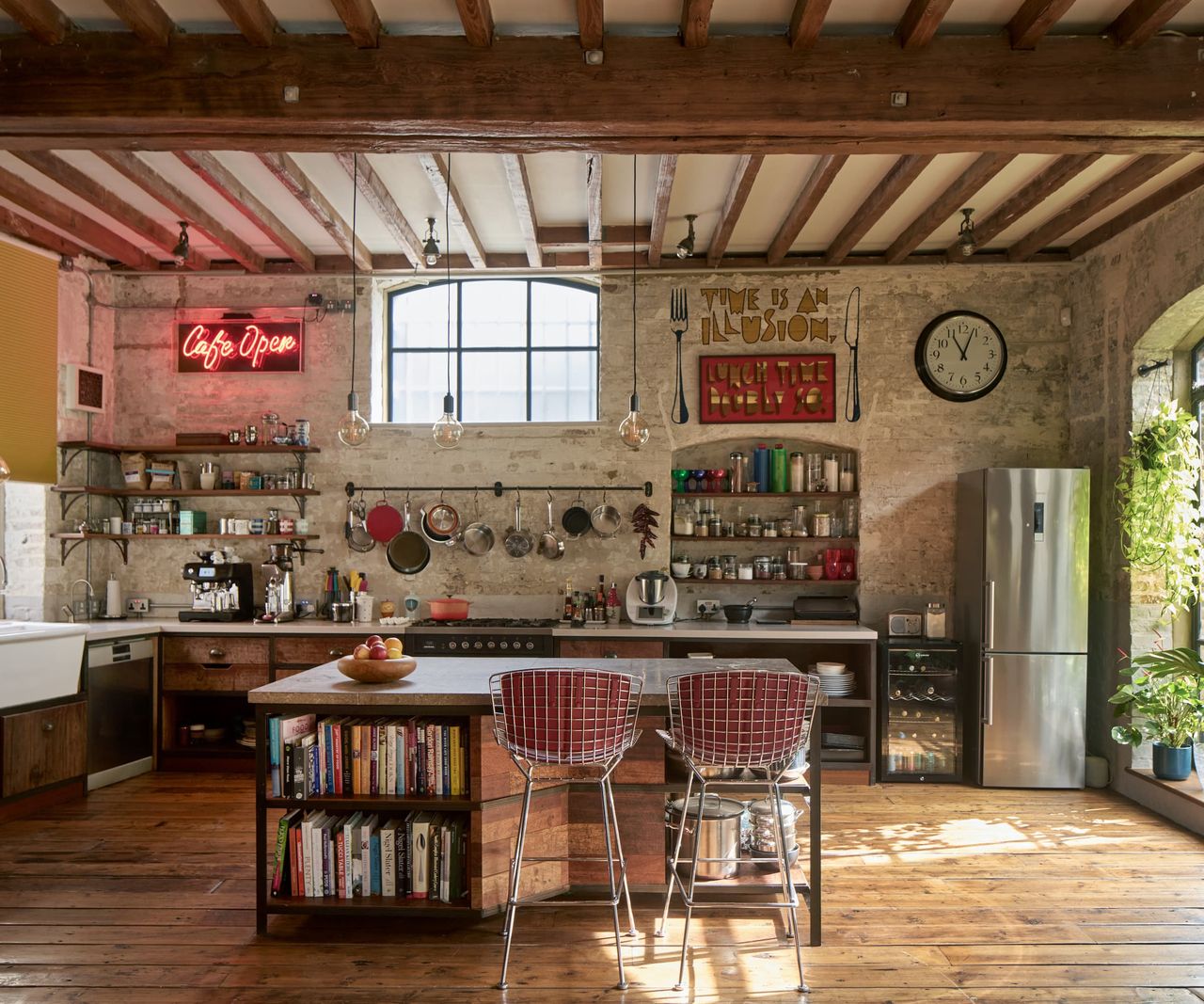 A kitchen with wooden panelled flooring and a small kitchen island with wooden cabinets