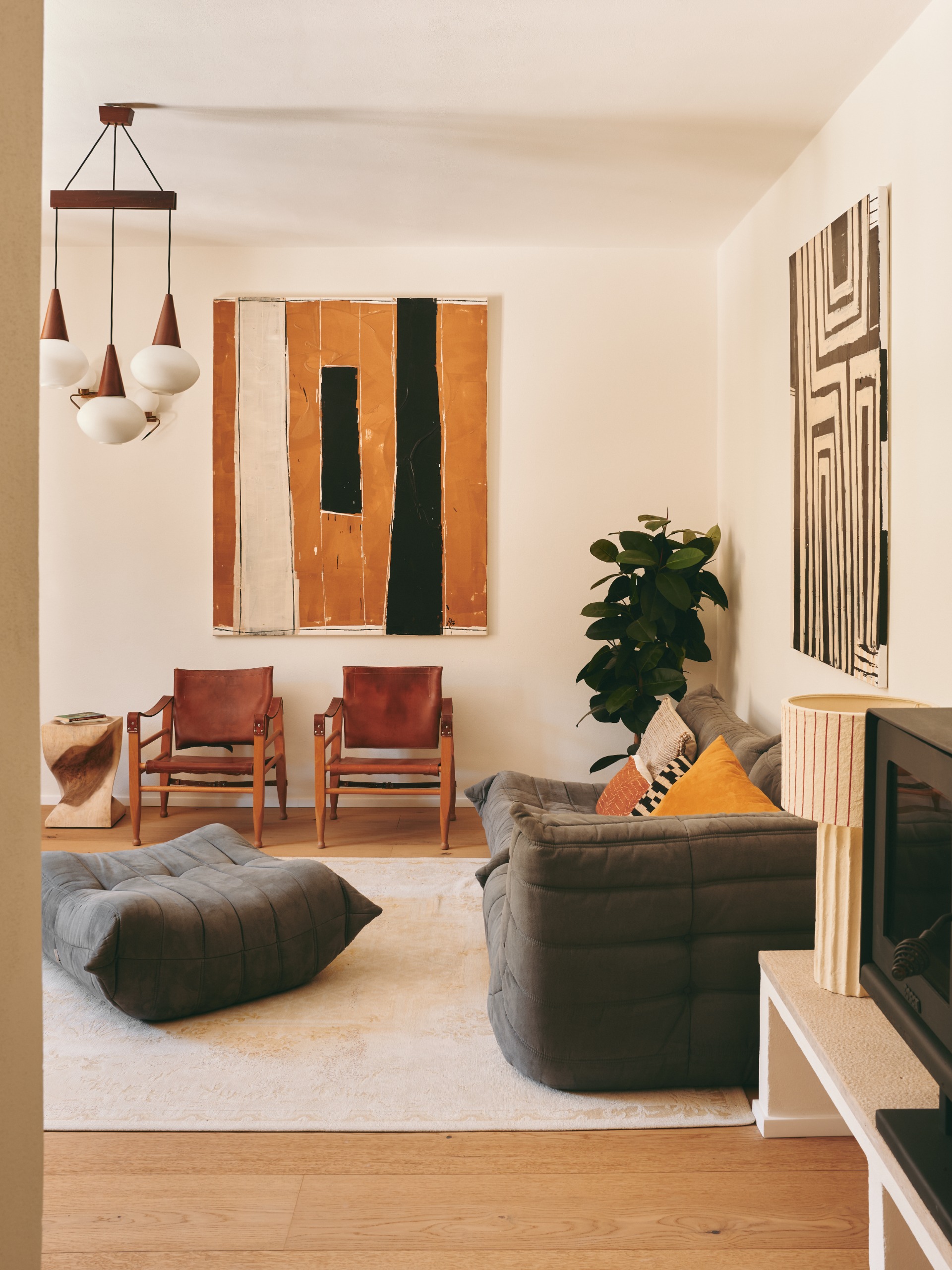 beautiful living room with grey togo sofa and large wall art