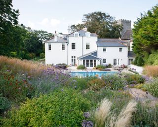 naturalistic style planting on a sloped country garden with pool