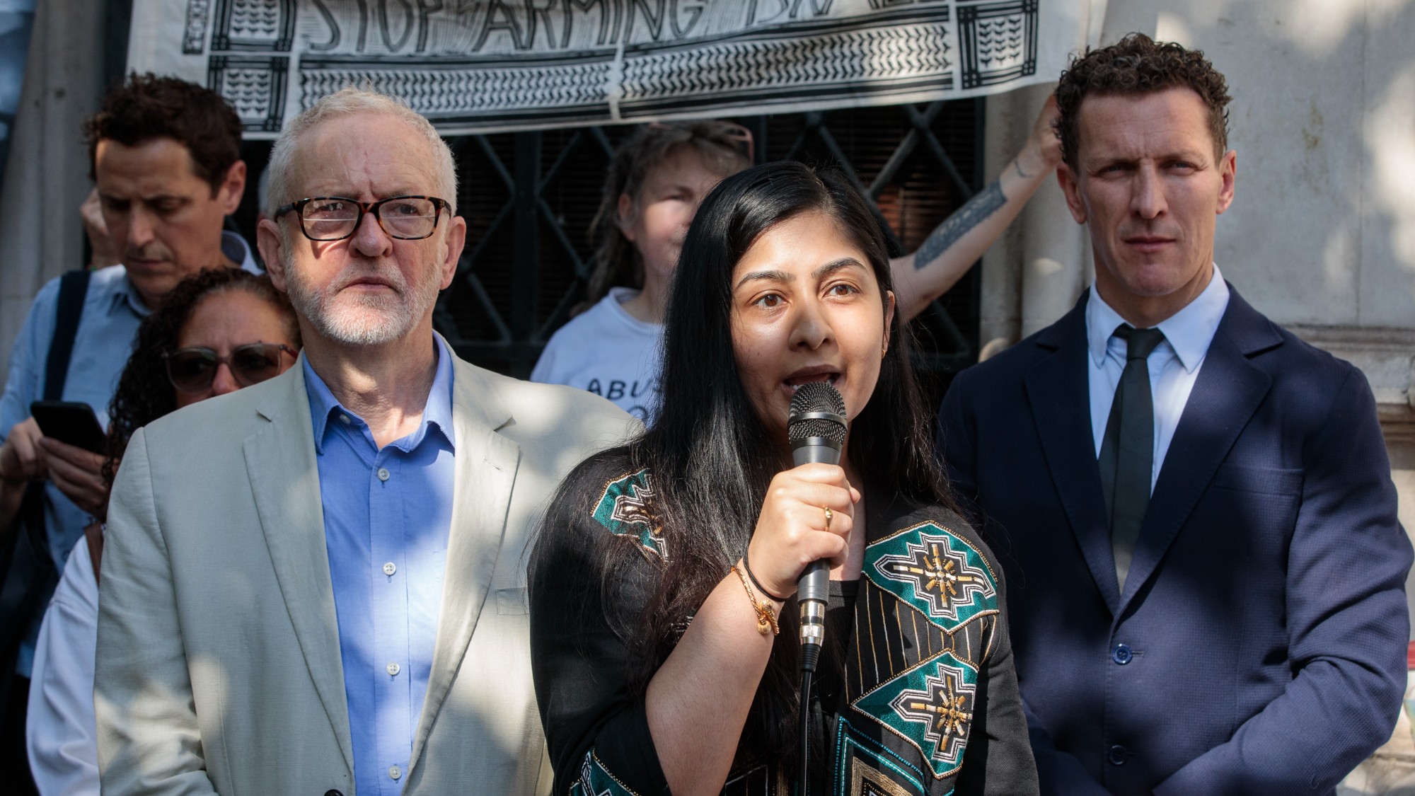 Sultana and Corbyn stand outside the Royal Courts of Justice