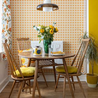 retro dining room with yellow wallpaper and table and chairs