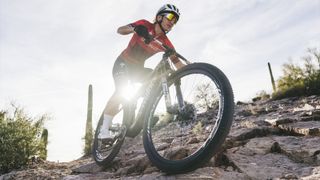 Mountain biker rides down a rocky trail using RockShox's new Flight Attendant
