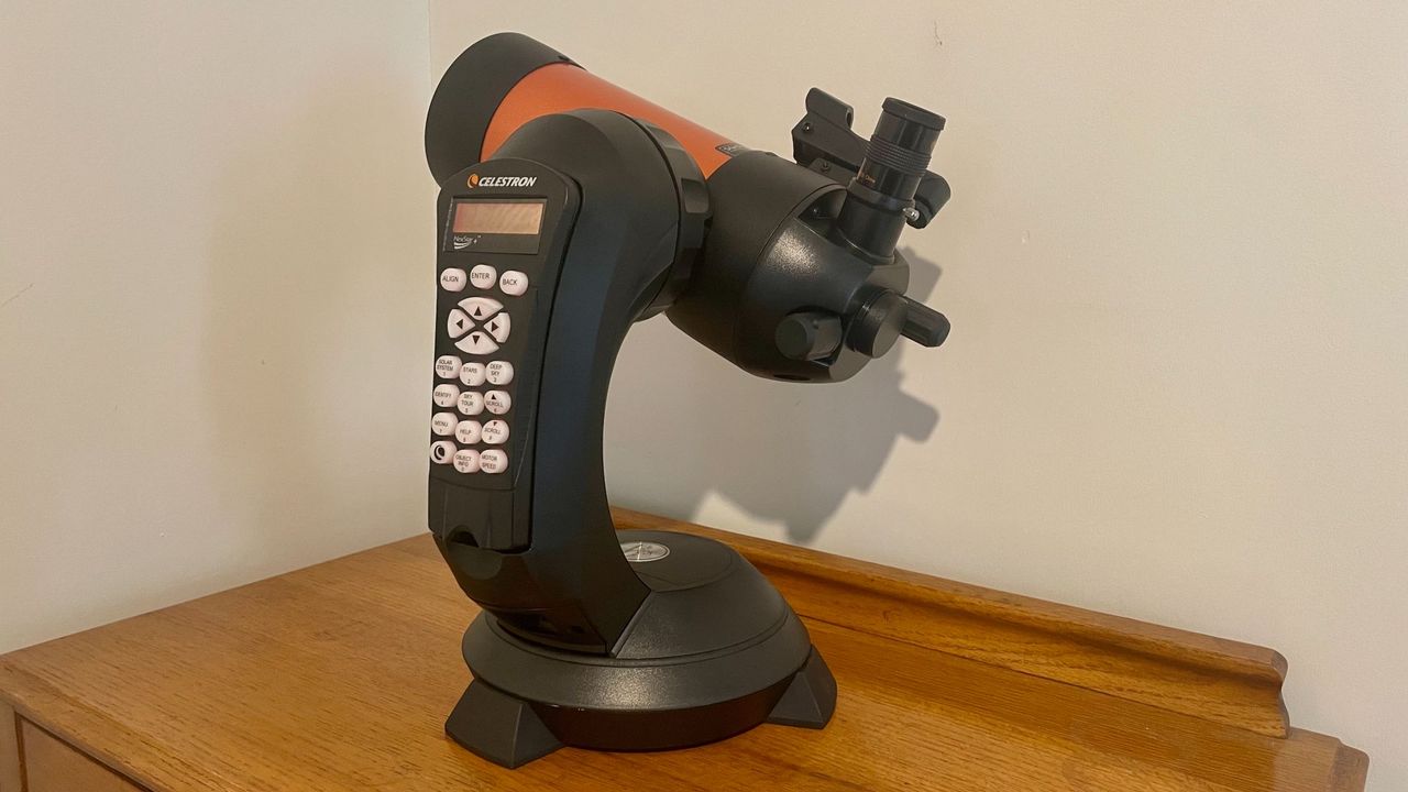 A rear-side view of the telescope on a wooden table