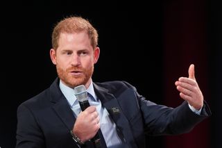 Prince Harry holds a microphone and wearing a suit while speaking at the 2024 Concordia Annual Summit in New York on September 23, 2024