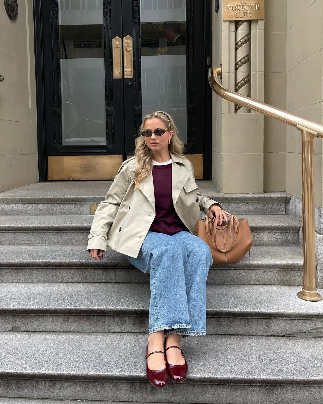 Izzy in a cropped trench coat and burgundy shoes