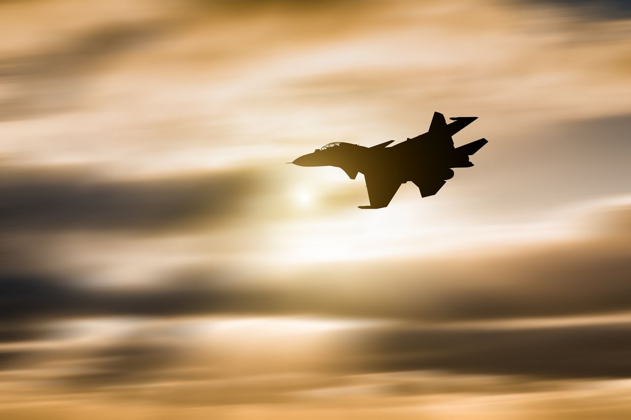 fighter plane at sunset