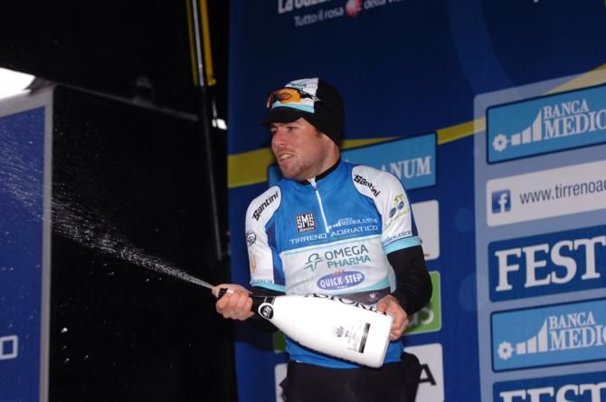 Mark Cavendish (Omega Pharma-Quick Step) celebrates on the podium after earning the leader's jersey.