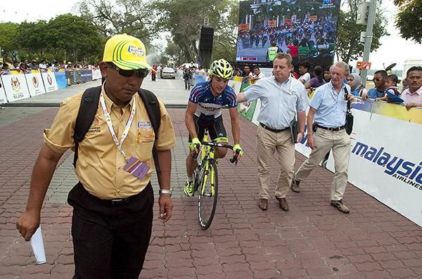 Stage winner Andrea Guardini (Farnese Vini) is escorted to the presentations as his win is shown on the big screen behind