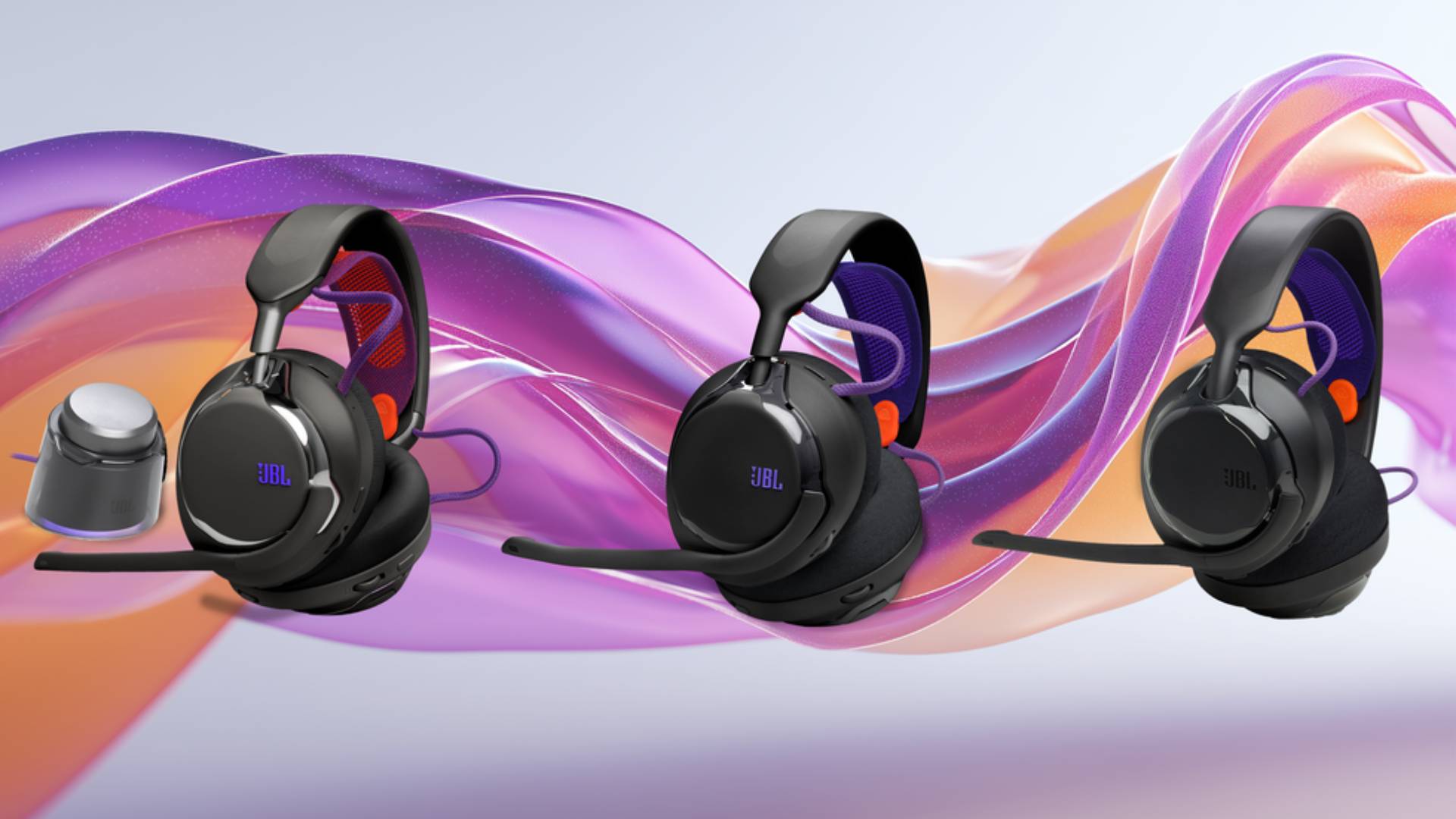 Official promo image of the new JBL headsets, the JBL Quantum 950, 650, and 250, with a purple and orange swirl background.