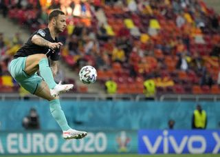 Austria’s Marko Arnautovic jumps to control the ball