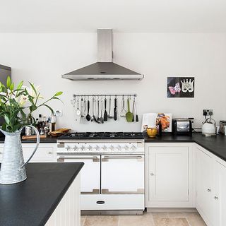 kitchen room with white walls and kitchen chimney