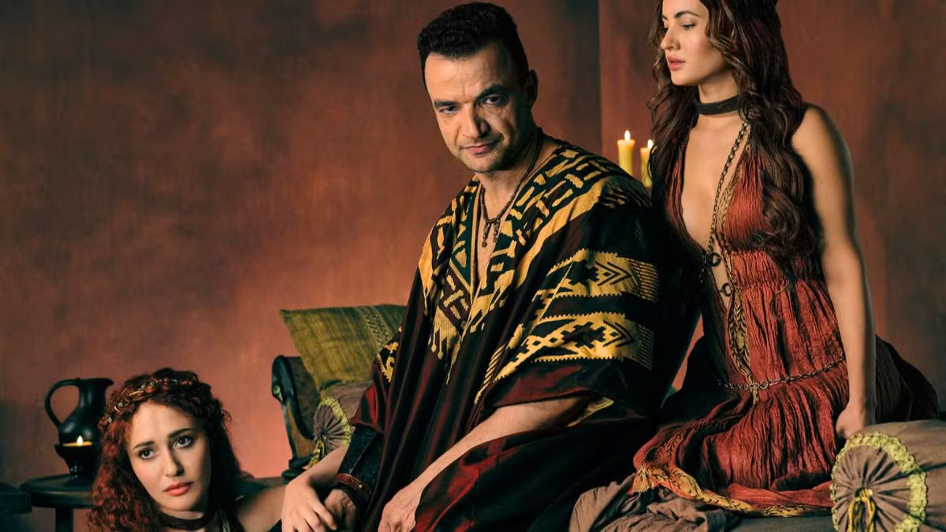 Ashur with two women either side of him