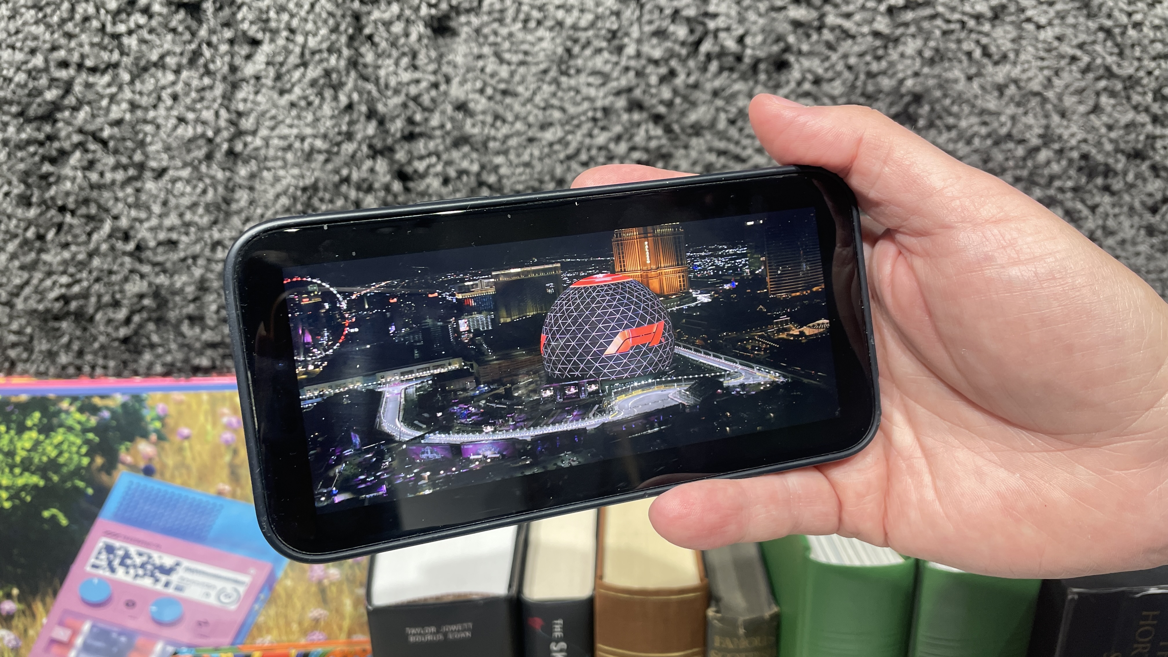 Scene from F1 the Movie being shown on an iPhone