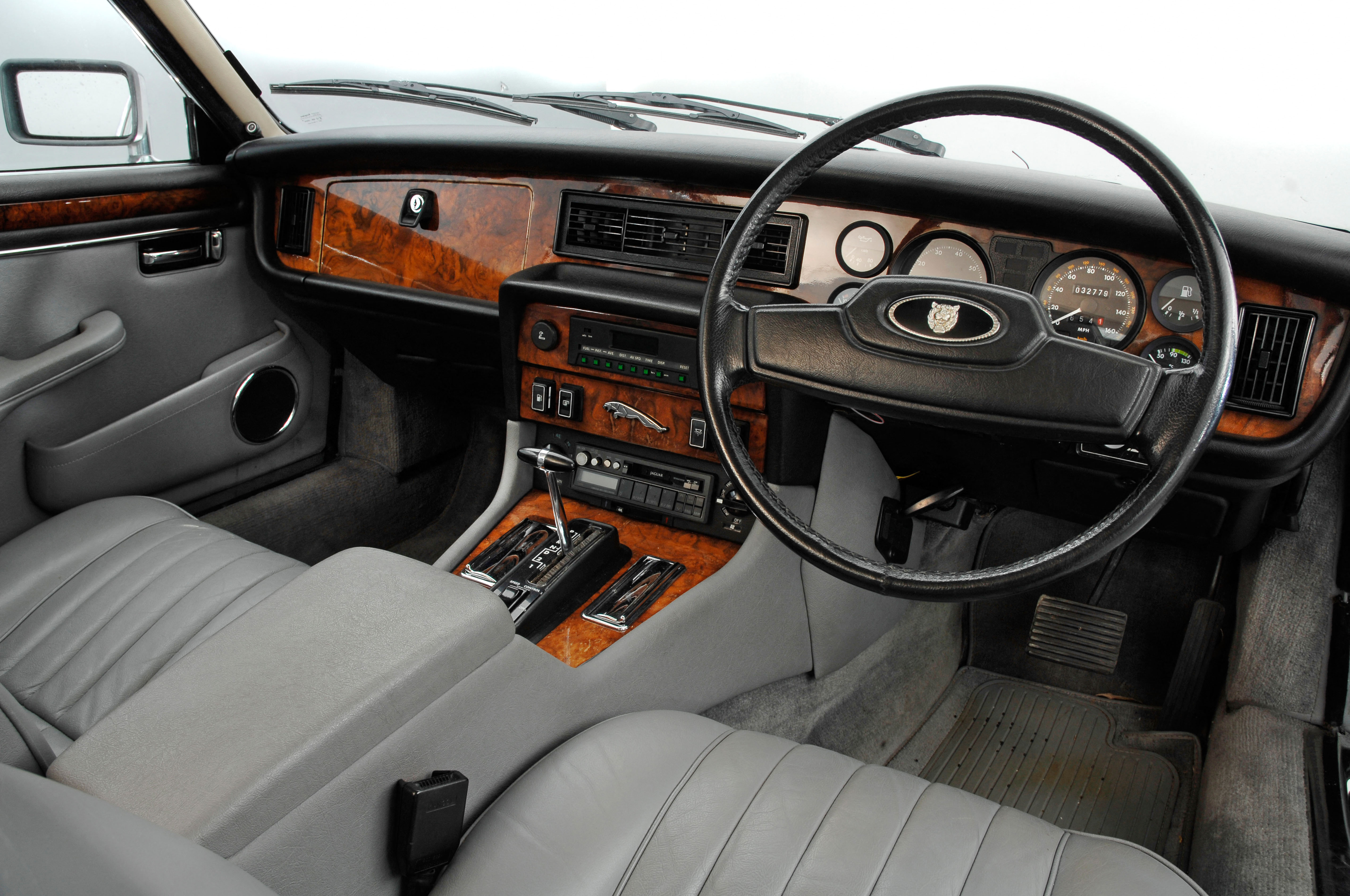 The inside of a 1987 sovereign XJ12 Jaguar. Lots of leather and walnut.