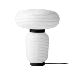A lantern style table lamp with black rims
