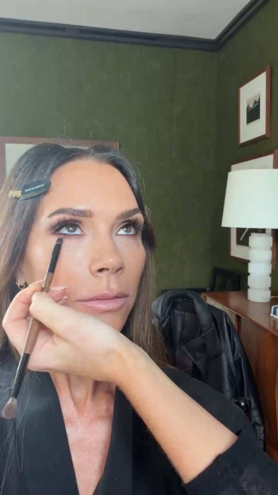 Victoria Beckham having her eye makeup done