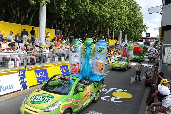 The pre-race Tour caravan signals racers will come through eventually