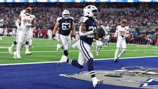 Rico Dowdle #23 of the Dallas Cowboys catch a pass for a touchdown during the first quarter in the game against the Washington Commanders at AT&T Stadium on November 23, 2023 