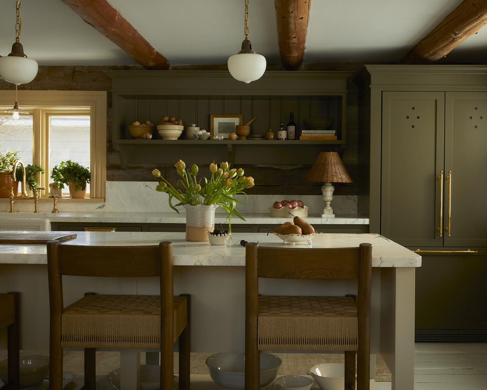 kitchen with dark green cabinets and white island