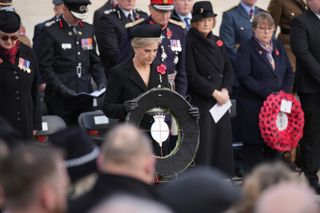 Duchess Sophie wearing a black coat and hat laying a wreath at an Armistice Day ceremony