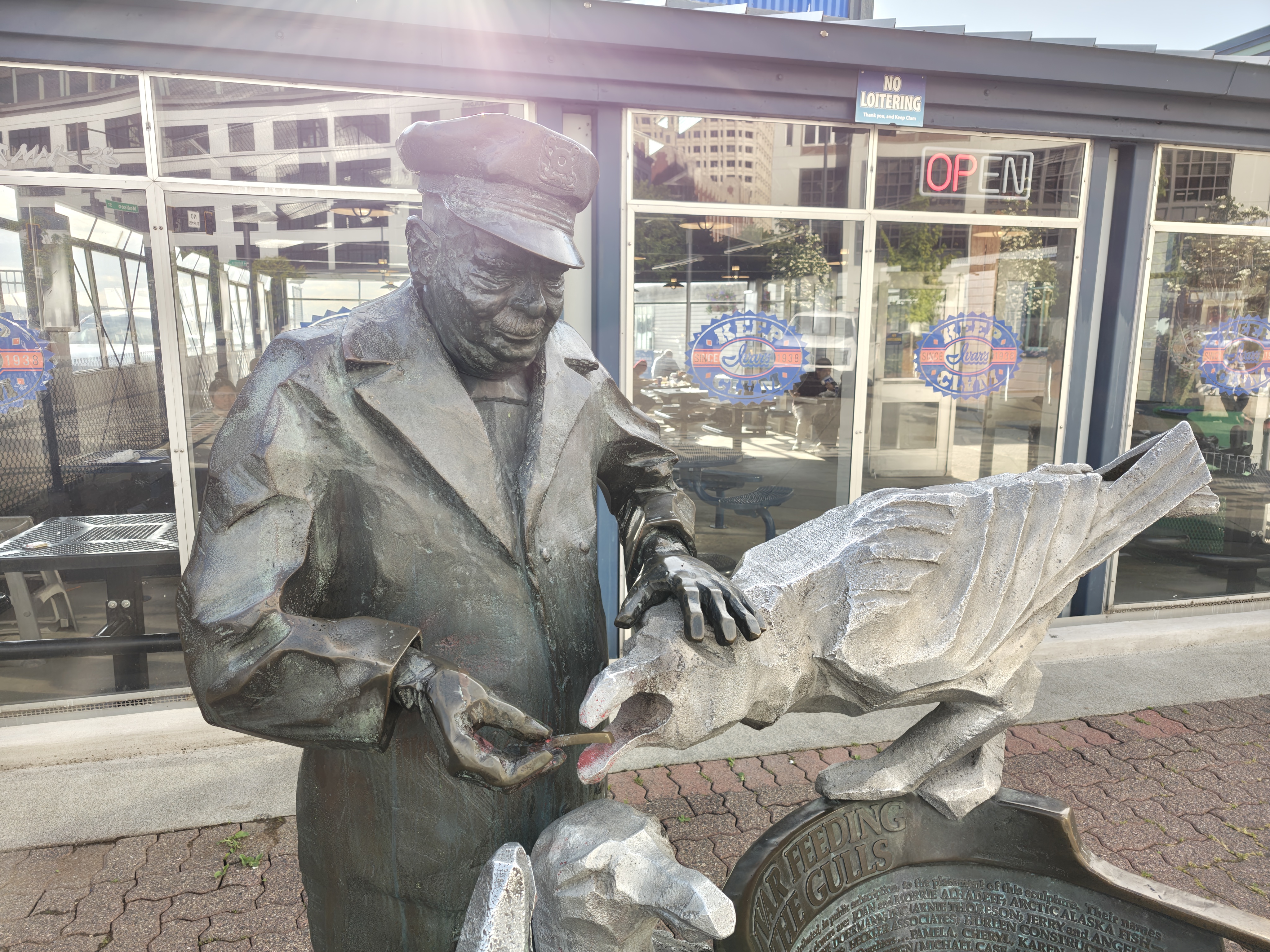 A statue of a man feeding a seagull