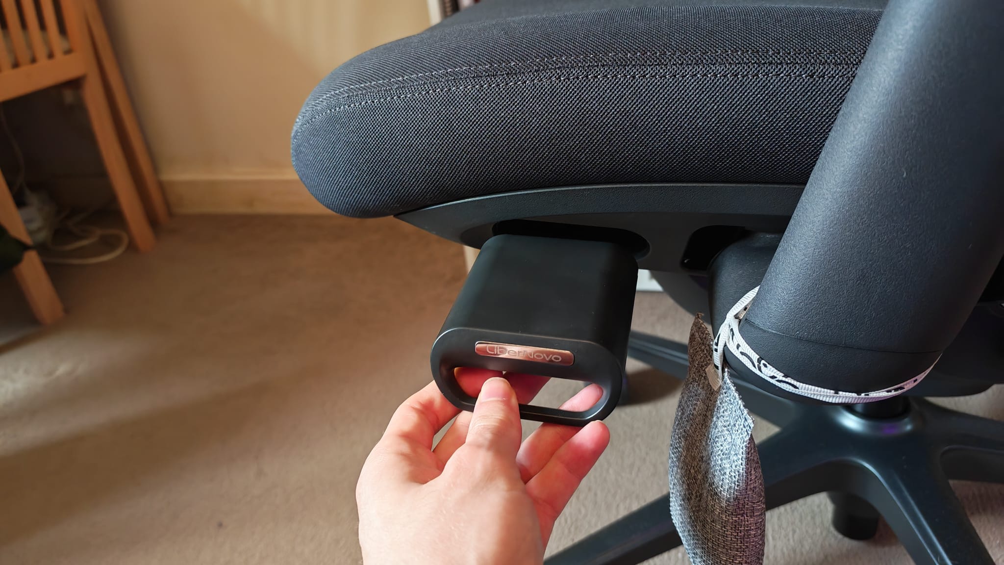 A reviewer installing the battery of the LiberNovo Omni Pro