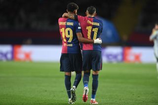 Raphinha of FC Barcelona celebrates with Lamine Yamal of FC Barcelona after scoring his team's third goal during the UEFA Champions League Round of 16 Second Leg match between FC Barcelona and Sport Lisboa e Benfica at Estadi Olimpic Lluis Companys.