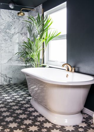 bathroom makeover with bath tub black walls and potted plants
