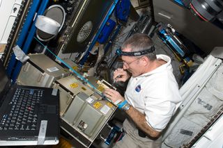 NASA astronaut Dan Burbank, Expedition 30 commander, works with the Major Constituent Analyzer Mass Spectrometer Assembly (MCA MSA) of the Atmosphere Revitalization system in the Tranquility node of the International Space Station. In the future, made-in-space parts may become the norm to fix equipment on the fritz.