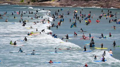 Surfers at Polzeath, Cornwall ©