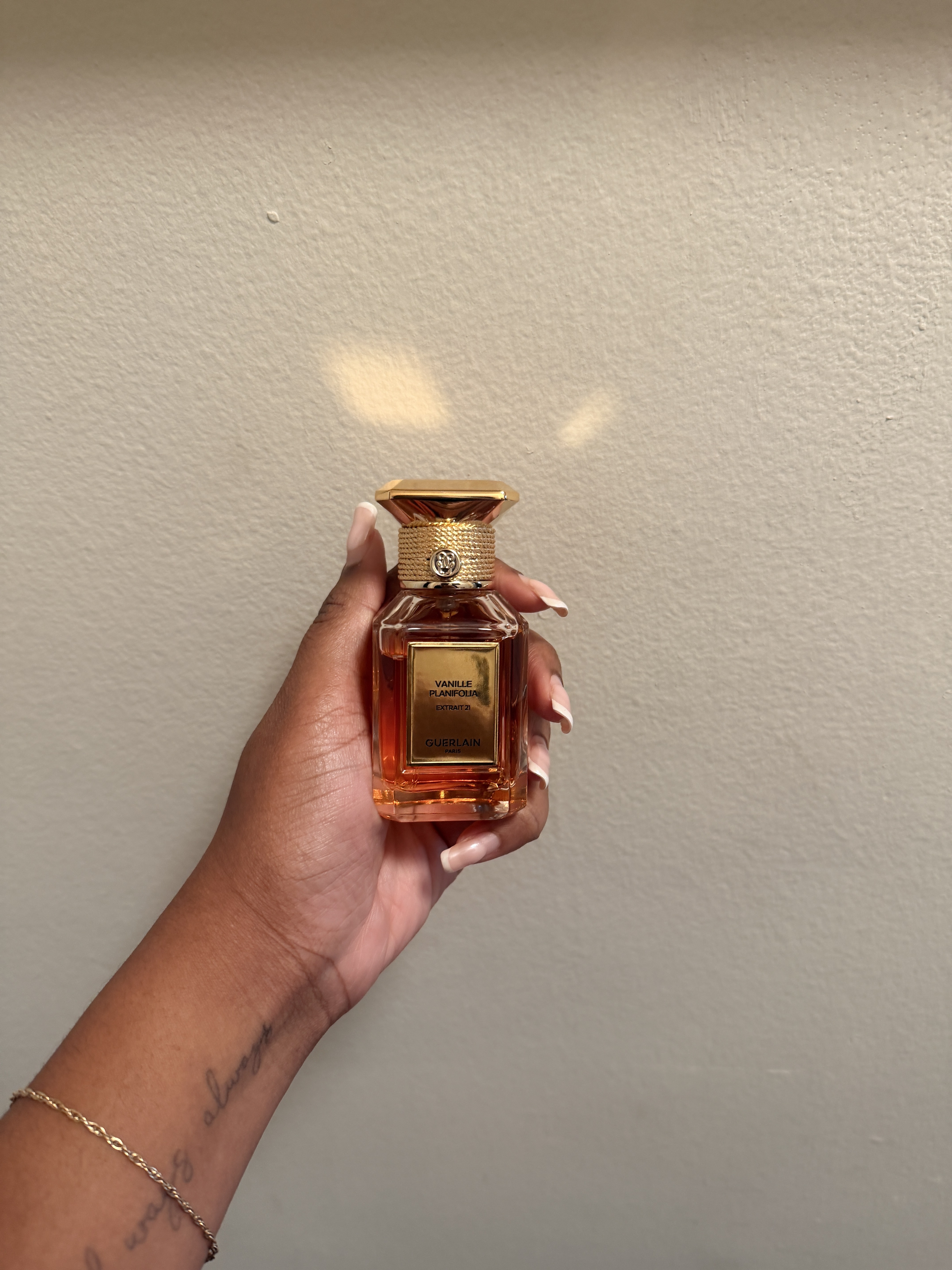 Ariel Baker holding Vanille Planifolia perfume.