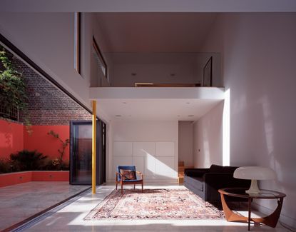 minimalist living room with red sofa