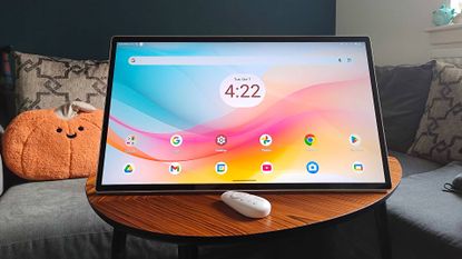 KTC MegPad portable monitor on coffee table with remote in front.