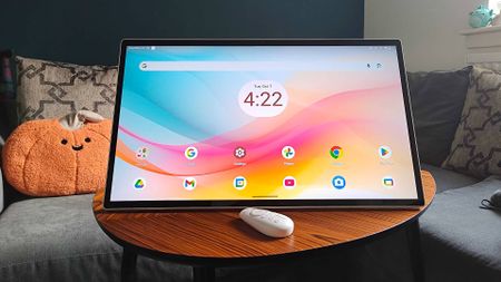 KTC MegPad portable monitor on coffee table with remote in front.