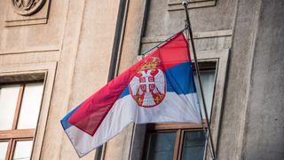 Low angle view of a Serbian flag on a building in Belgrade