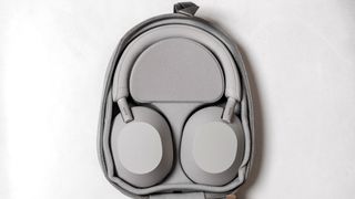 Sony WH-1000XM5 headphones laying flat in case.