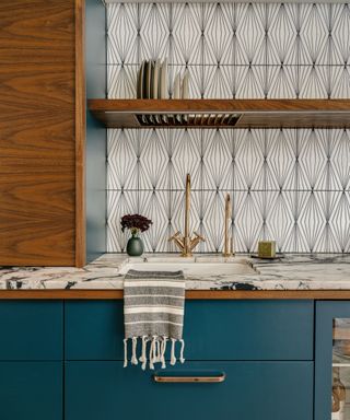 teal kitchen with dark wood accents and a geometric tile backsplash