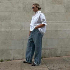 Alexis in jeans, white blouse and black mesh flats