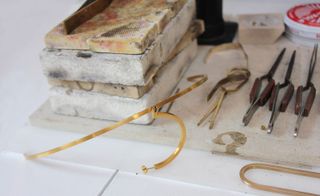 Gold ‘Bridge’ and ‘Cusp’ earpieces, among Sweetnam’s tools on her workbench