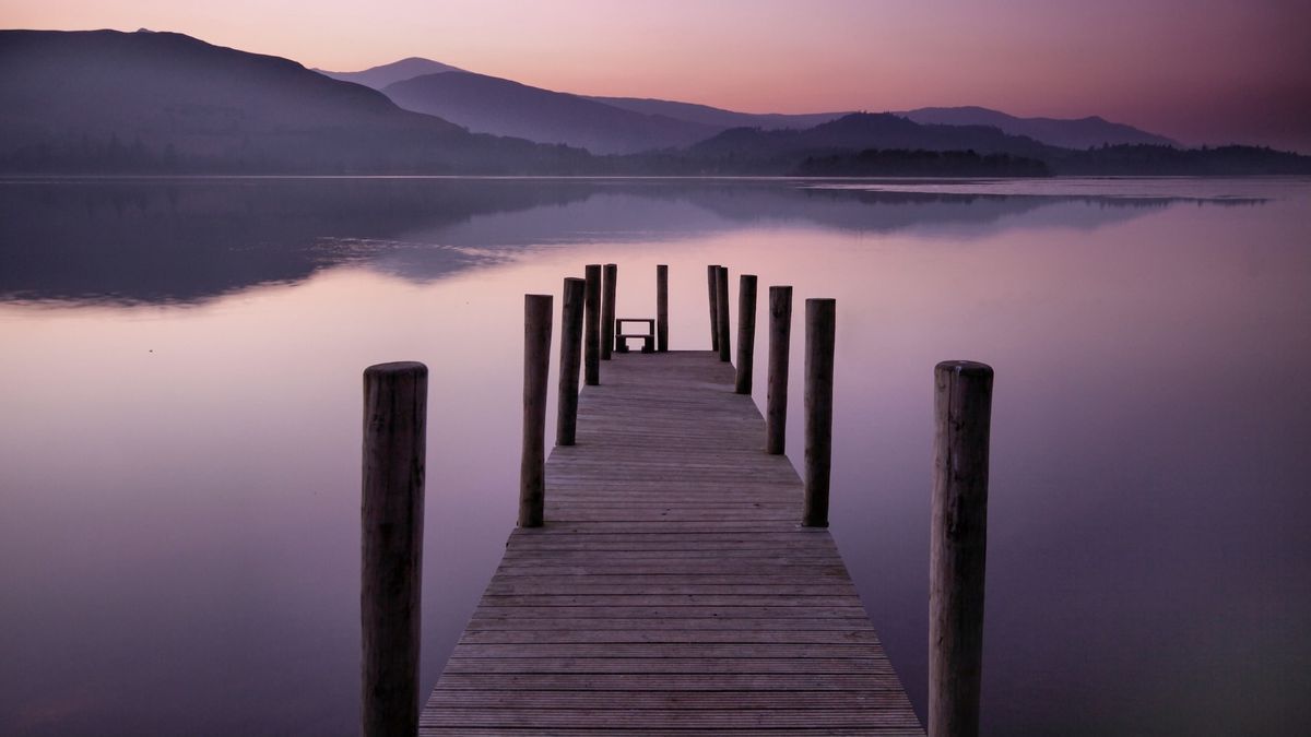 Pier leading into a lake at dusk