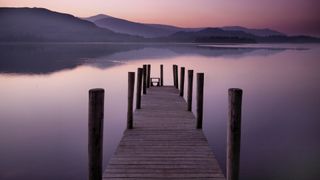 Pier leading into a lake at dusk