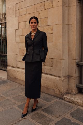 woman wearing blazer, skirt, and kitten heels