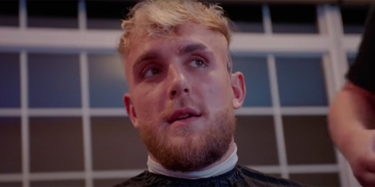 Jake Paul sitting in a barber&#039;s chair and getting his haircut.