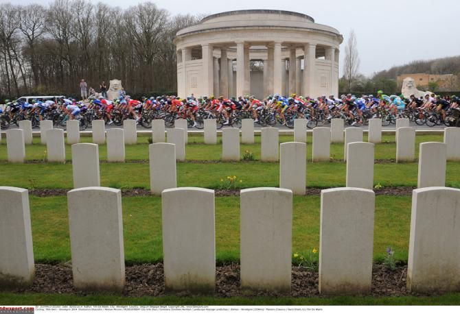 The Gent-Wevelgem peloton passes a cemetary