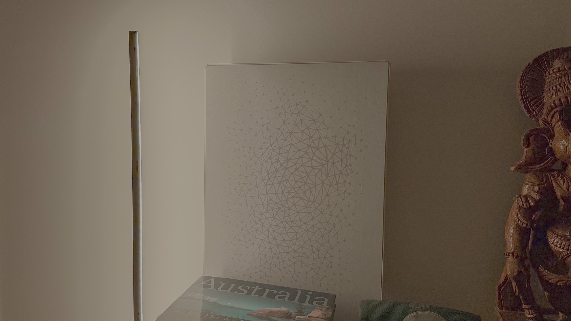 Nanoleaf Smart Multicolor Floor Lamp washing a wall with warm white light