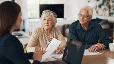 A wealthy, but stressed senior couple sit with a financial adviser.