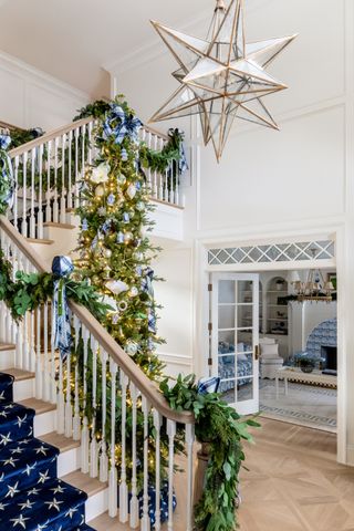 Christmas stair decor garland with blue plaid ribbon by The Fox Group