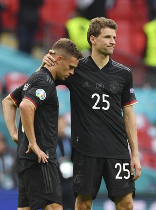 Germany’s Thomas Muller, right, consoles Joshua Kimmich