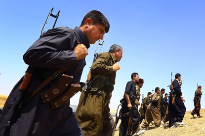Peshmerga fighters stand guard outside of Mosul.